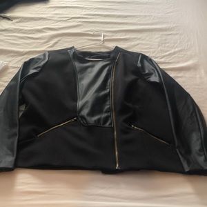 Black faux leather. Brand new. Never worn